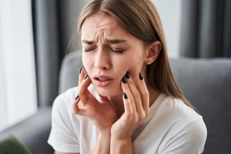 A young woman in pain gasping her jaw