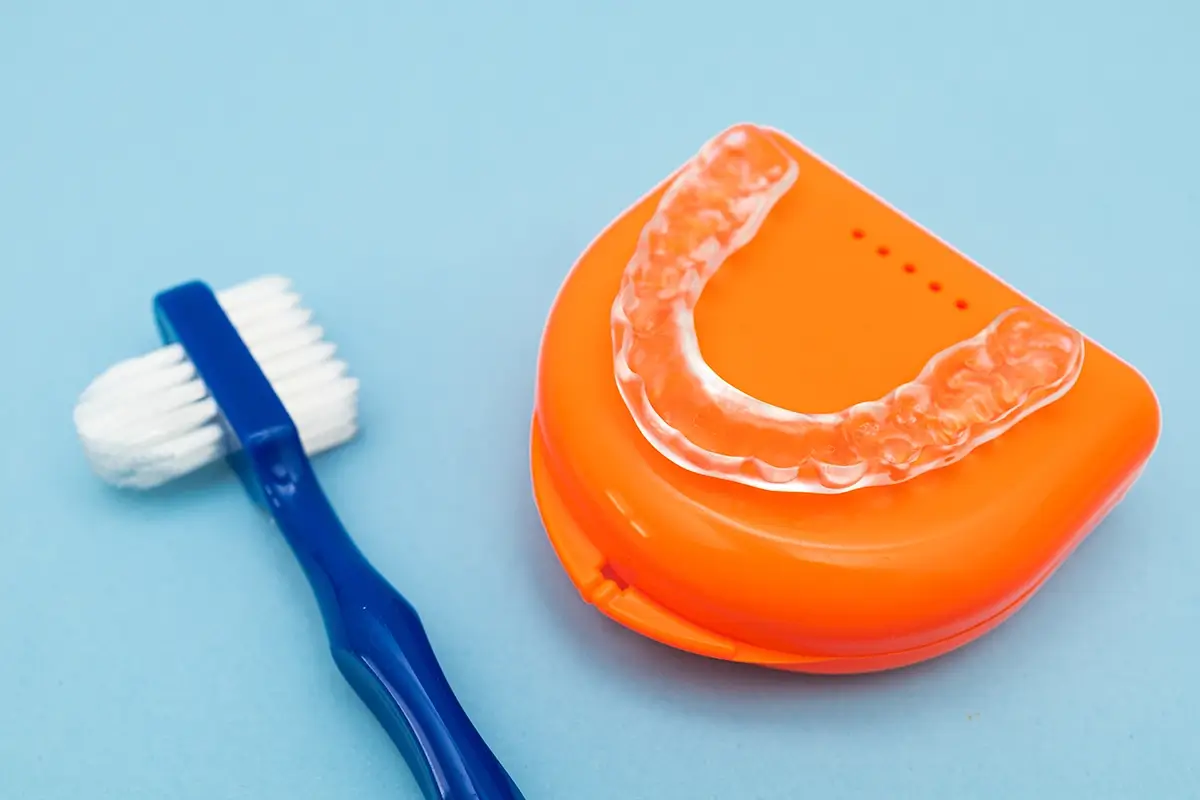 Dental Night Guard and Toothbrush on Colorful Background for Teeth Protection and Oral Hygiene