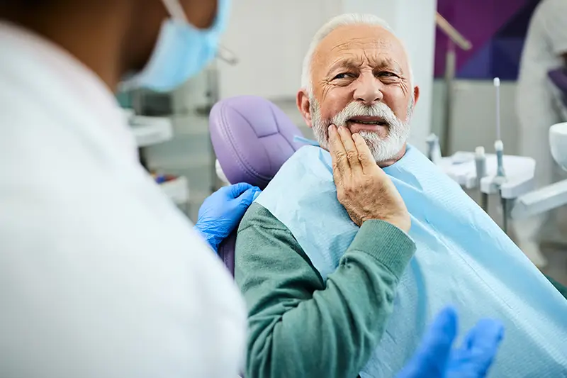 A dental crown sitting on a person's finger
